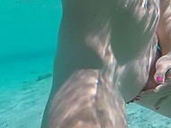 Tourist films a naked girl with shaved pussy underwater then jerks off on the beach 8