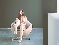 Slender Euro beauty in high boots fingers trimmed pussy while relaxing solo on unusual chair 8