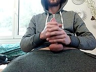 Bearded guy in hoodie shows how hands help him satisfy hard cock when he is alone 10