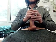 Bearded guy in hoodie shows how hands help him satisfy hard cock when he is alone 6