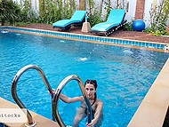 Busty girl with long pigtails swims naked in the pool and masturbates on the sun lounger 11