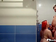Girl with bright red hair gives a blowjob to guy in the shower and receives facial cumshot 11