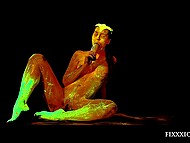 Attractive princess covered in amazing fluorescent paint relaxes solo using a dildo 4