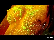 Attractive princess covered in amazing fluorescent paint relaxes solo using a dildo 6