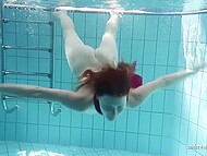 Redhead beauty takes off her sexy bikini and swims in the pool surrounded by young girlfriends 11