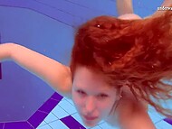 Redhead beauty takes off her sexy bikini and swims in the pool surrounded by young girlfriends 5