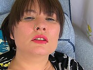 Appetizing brunette in black stockings sits in a chair to masturbate her trimmed pussy with a toy 9