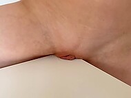 Naked girl rubs her shaved pussy on the corner of the table, getting orgasms during this sexy process 5