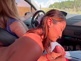 Two girlfriends invited a guy for a ride in a car and pleased him with a blowjob during the trip