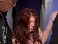Two lovers of BDSM games roughly spank a red-haired girl in stockings on the ass and then fuck her 5
