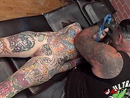 Big titted brunette gets a forehead tattoo while she is naked 7