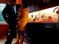 MILF in yellow raincoat and boots postpones making dinner to give the husband a handjob