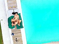 Tanned brunette with beautiful breasts enjoys summer by having sex by the pool 7