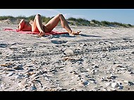 Naked girl with big boobs masturbates on the beach and becomes target for the voyeur 10